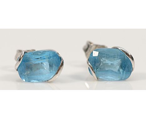 A pair of 14K white gold blue topaz earrings with scroll backs, 1.1g