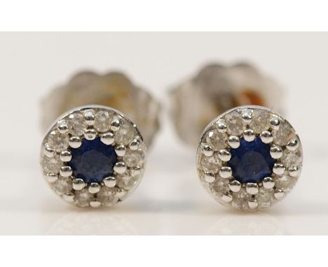 A pair of 18ct white gold sapphire and diamond cluster earrings with scroll backs, 1.2g