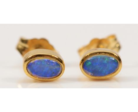 A pair of 18ct gold opal earrings with scroll backs, 1.3g