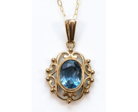 A 9ct gold blue topaz pendant with a chain, 2g