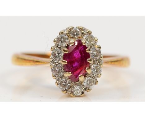 An 18ct gold ruby and diamond cluster ring, J, 2.9g
