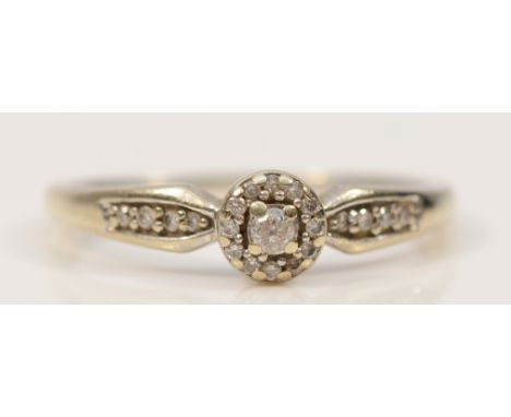 A 9ct white gold diamond cluster ring with diamond set shoulders, O, 1.8g