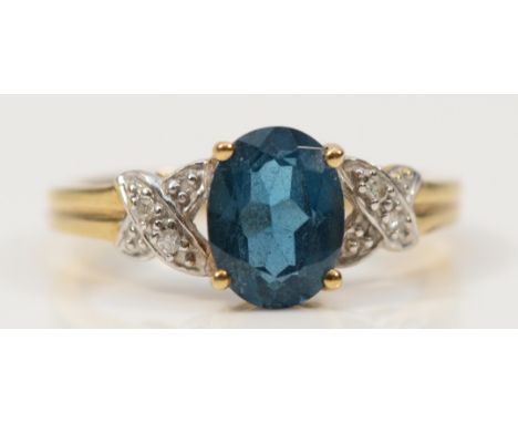 A QVC 9ct gold blue topaz solitaire ring with diamond set shoulders, K, 2g