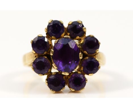 A 9ct gold purple gemstone cluster ring, 8mm x 6mm central gemstone, M, 6.8g