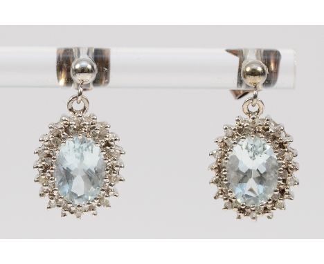A pair of 9ct white gold diamond and aquamarine earrings with scroll backs, 2.8g