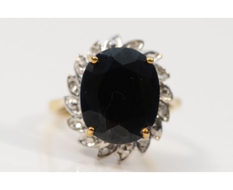 A 9ct gold sapphire and diamond cluster ring, 13mm x 10mm sapphire, H 1/2, 3.4g