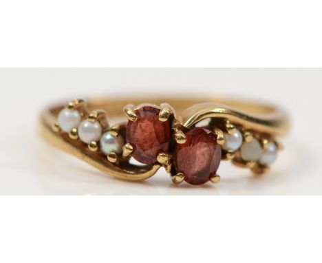 A 9ct gold garnet and seed pearl cross over ring, Edinburgh 1989, L, 1.7g