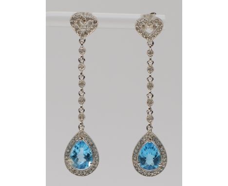 A pair of 14K white gold diamond and blue topaz drop earrings with scroll backs, 50mm, 4.8g