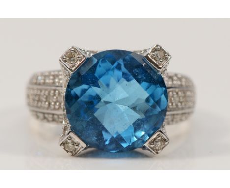 A 14K white gold blue topaz and brilliant cut diamond dress ring, 13mm central gemstone, N, 6.2g
