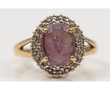 A 9ct gold diamond and amethyst cluster ring, hallmarks worn, O, 3.6g
