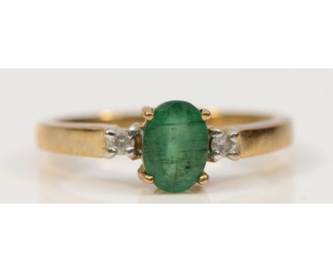 A 9ct gold emerald solitaire ring with brilliant cut diamond set shoulders, M 1/2, 2.4g