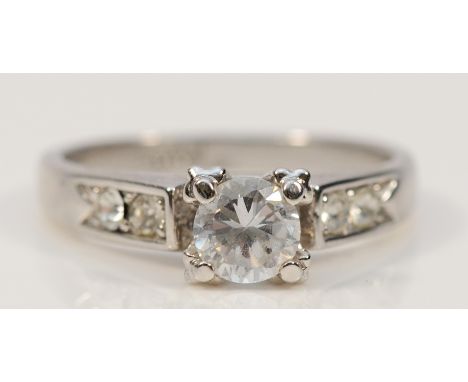 A white metal ring stamped 18K, white gemstone dress ring, M