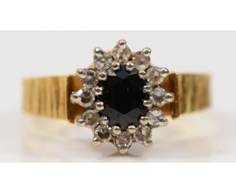 An 18ct gold sapphire and diamond cluster ring, M, 6.3g