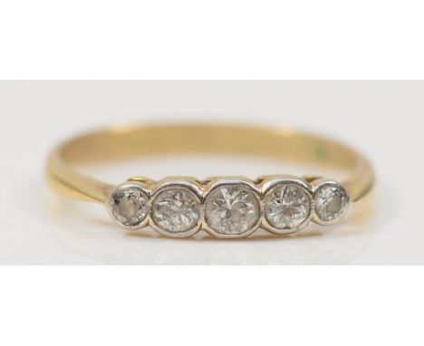 A 9ct gold brilliant cut diamond five stone ring, hallmarks removed possibly due to resizing, R, 2.2g