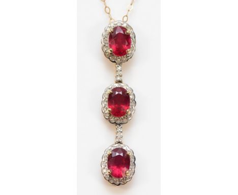 A 9ct gold ruby and diamond cluster pendant with a chain, 37mm, 2.9g