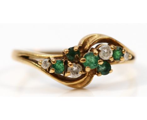 A 9ct gold emerald and brilliant cut diamond cross over ring, R, 2.1g