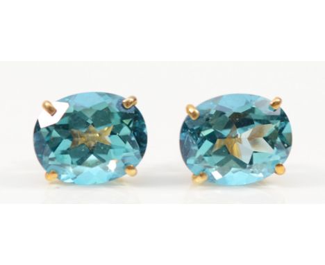 A pair of 14K gold blue gemstone earrings with scroll backs, possibly blue topaz, 10mm x 8mm, 2.5g