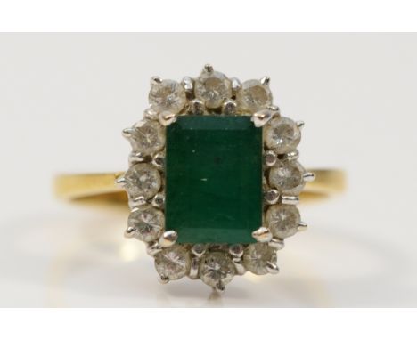 An 18ct gold brilliant cut diamond and emerald cluster ring, 8mm x 4mm emerald, J 1/2, 4.4g