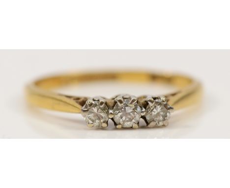 An 18ct gold and platinum three stone brilliant cut diamond ring, L, 1.8g