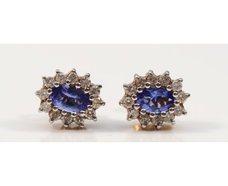 A pair of 9ct gold blue and white gemstone cluster earrings with scroll backs, 2.4g
