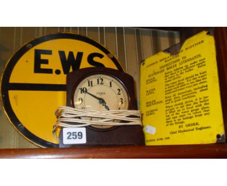 Bakelite L.S.W.R electric clock, a L.M.S enamel notice for "instructions to Stationary Boiler Attendants" and a round enamel 