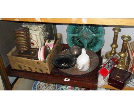 Shelf of assorted items including carved tray, a pair of brass candlesticks etc.