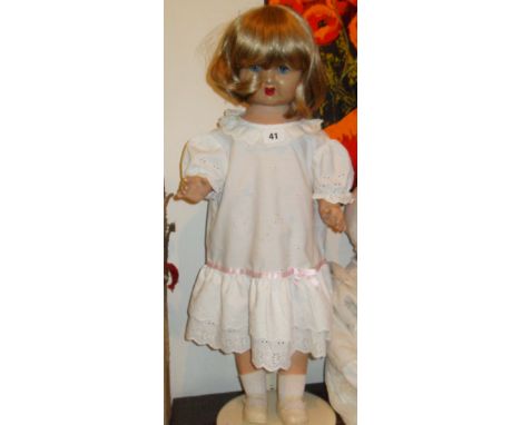Vintage composite doll on stand with internal wind-up speaker (not working)