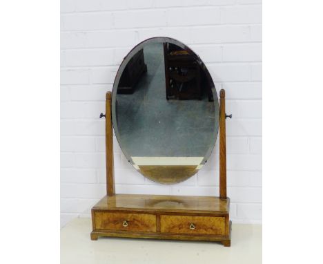 A Whytock "& Reid style walnut dressing mirror, the oval plate on tapering side supports over a rectangular base fitted with 