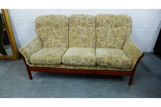 An Ercol style three seater sofa with floral upholstered cushions, 96 x ...