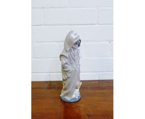 A Nao Spanish porcelain figure of a boy in a hooded coat with his dog at his feet, 28cm high 