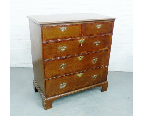 An  oak chest, the rectangular top with moulded edge over two short drawers and  three graduating long drawers, on bracket fe
