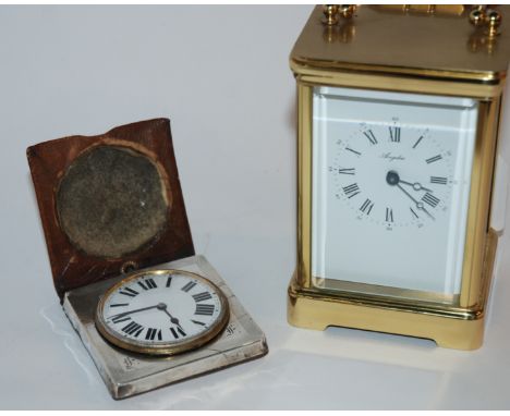 A brass carriage clock and a silver cased travel clock (2) Condition Report: Available upon request