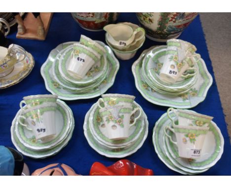 A Paladin China teaset with fluted cups comprising two cake plates, eleven side plates, eleven saucers, ten cups, milk and su