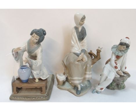 A Lladro figure of a Geisha, a sitting girl and a Nao figure of a Jester Condition Report: Geisha missing flower in hand, oth