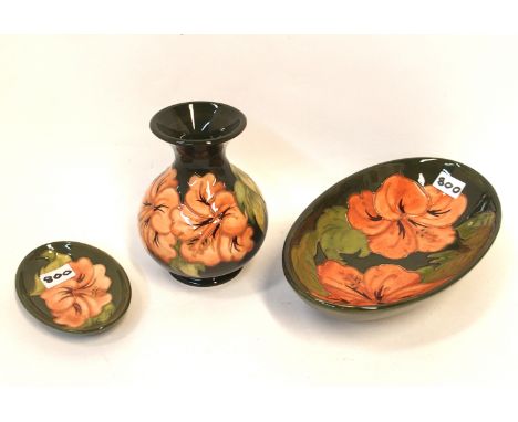 A Moorcroft hibiscus pattern vase with matching dish and pin dish Condition Report: Light crazing to all pieces. 