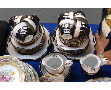 A Noritake teaset, the black and white ground with chrysanthemums comprising two cake plates, seven cups, ten saucers, ten pl