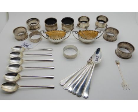 A lot comprising a pair of silver boat shaped salts, Birmingham 1876, a pair of salts, no liners, eight napkin rings, six sil