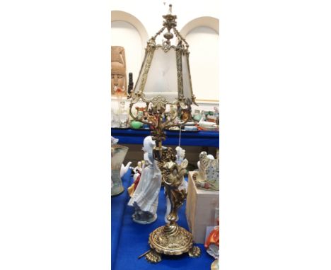 A gilded figural table lamp modelled as a woman with glass panel shade Condition Report: Available upon request