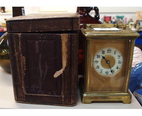 A brass cased carriage clock with travelling case Condition Report: Available upon request