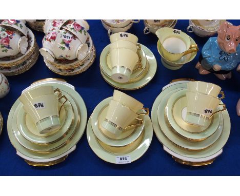 A Royal Albert lemon and pale green gazed teaset comprising nine cups, twelve saucers, ten side plates, two cake plates, milk