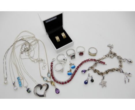 A silver ruby line bracelet with matching ring, a silver charm bracelet with diamond set charms and other items of silver and
