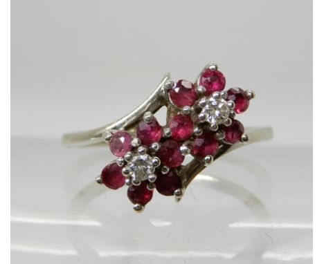 A 14k white gold ruby and diamond twin flower ring, size P, weight 2.8gms Condition Report: Available upon request