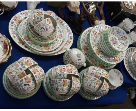 A Minton Haddon Hall dinner service comprising eight dinner plates, eight pudding bowls, six soup bowls, fifteen cups and sau