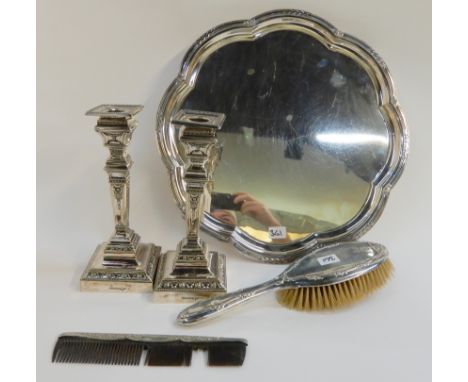 A lot comprising a pair of silver plated candlesticks, a salver, a silver hair brush and a comb Condition Report: Available u