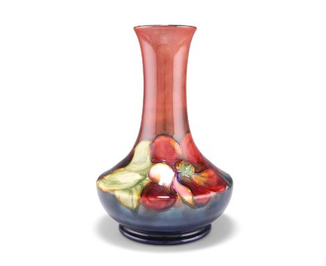 A WALTER MOORCROFT FLAMBÉ POTTERY VASE, squat baluster form with a long flared neck, 'Clematis' pattern, tubelined and hand-p