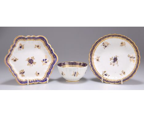 A CAUGHLEY 'DRESDEN FLOWERS' TEA BOWL, SAUCER AND HEXAGONAL STAND, CIRCA 1780-1785,&nbsp;of fluted form, decorated in blue an