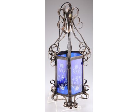 A STRAPWORK LANTERN, 19TH CENTURY, the scrolling hand wrought iron frame with six floral-etched and flashed blue glass panels