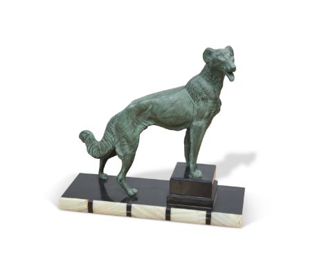 AN ART DECO STYLE PATINATED SPELTER MODEL OF A DOG, on a marble base. 37cm high
