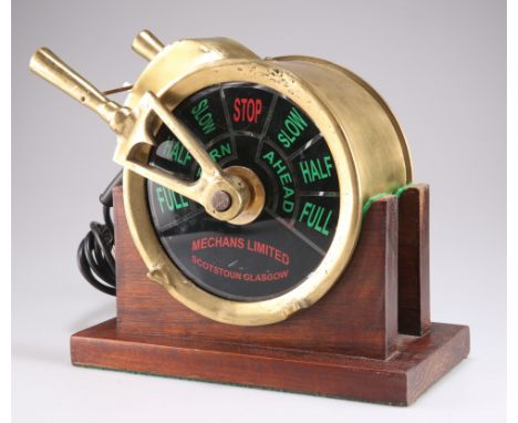 A SHIP'S ENGINE ORDER TELEGRAPH HEAD,&nbsp;by Mechans Limited, Scotstoun Glasgow, as a desk lamp, on a wooden stand. Stand 27