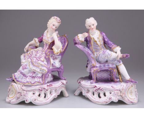 A PAIR OF DRESDEN PORCELAIN FIGURES, modelled as a seated 18th Century lady and gentleman, on pierced scrolling bases, decora